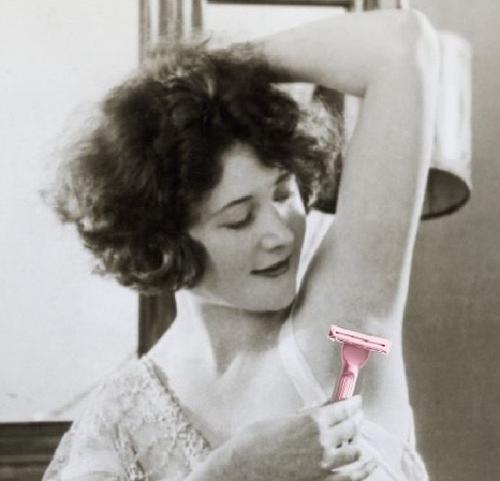 Vintage black and white photo of a woman shaving with a hanni weighted razor