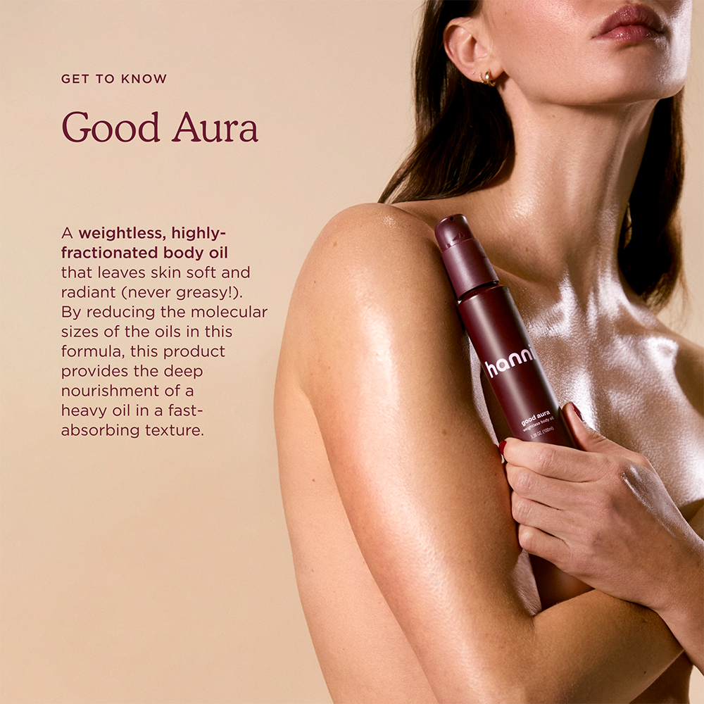 Model holding a bottle of Good Aura, with product description text displayed on screen.